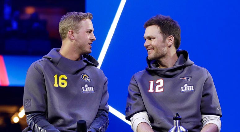 Los Angeles Rams' Jared Goff talks to New England Patriots' Tom Brady during Opening Night for the NFL Super Bowl 53 football game Monday, AP DO NOT USE