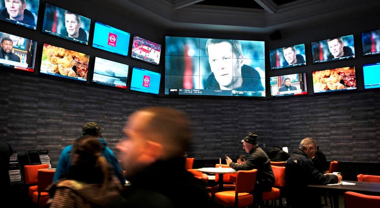 patrons visit the sports betting area of Twin River Casino in Lincoln, R.I. AP DO NOT USE