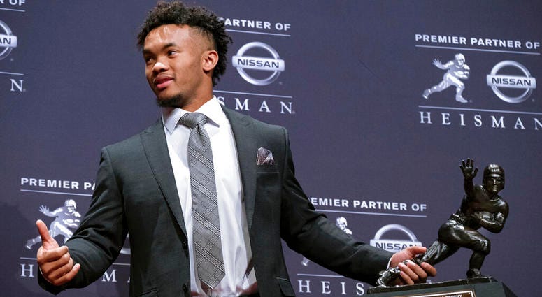 Oklahoma quarterback Kyler Murray holds the Hesiman Trophy after winning the award in New York AP DO NOT USE