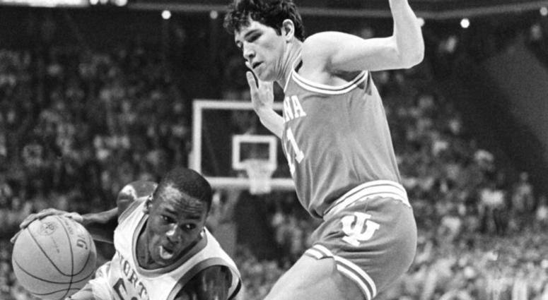 This March 23, 1984, file photo shows North Carolina forward Michael Jordan, trying to drive past Indiana forward Mike Giomi at Omni Coliseum in Atlanta Ga. DO NOT USE