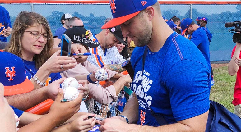 New York Mets' Tim Tebow signs autographs at spring training baseball practice Saturday, Feb. 16, 2019, in Port St. Lucie, Fla New York Mets' Tim Tebow signs autographs at spring training baseball practice Saturday, Feb. 16, 2019, in Port St. Lucie, Fla