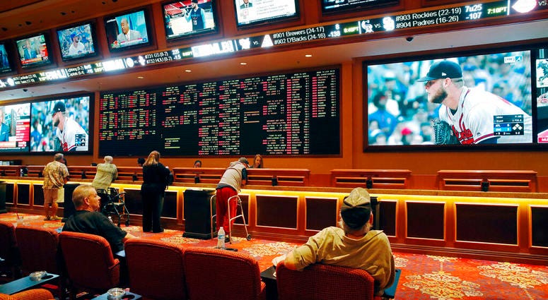 people make bets in the sports book at the South Point hotel and casino in Las Vegas. AP DO NOT USE