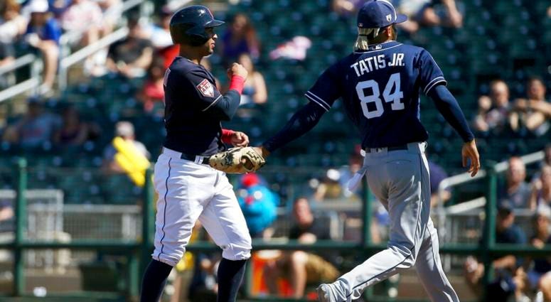 San Diego Padres' Fernando Tatis Jr. (84) tags out Cleveland Indians' Leonys Martin, left, in a rundown during the third inning of a spring training baseball game Monday, March 18, 2019, in Goodyear, Ariz. AP DO NOT USE