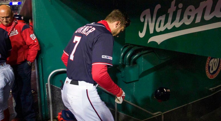 Washington Nationals' Trea Turner heads to the clubhouse after a pitch hit his hand while batting during the first inning of a baseball game against the Philadelphia Phillies at Nationals Park, Tuesday, April 2, 2019, in Washington. AP DO NOT USE