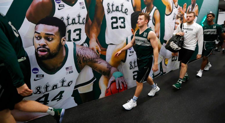 Michigan State guard Jack Hoiberg walks to the court for a practice session for the semifinals of the Final Four NCAA college basketball tournament, Friday, April 5, 2019, in Minneapolis AP DO NOT USE