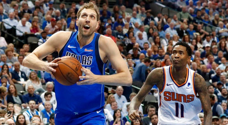 Dallas Mavericks forward Dirk Nowitzki (41) drives past Phoenix Suns guard Jamal Crawford (11) to the basket for a dunk during the second half of an NBA basketball game in Dallas, Tuesday, April 9, 2019. AP DO NOT USE