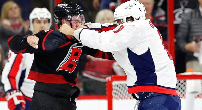 Washington Capitals' Alex Ovechkin, right, of Russia, punches Carolina Hurricanes' Andrei Svechnikov, also of Russia, during the first period of Game 3 of an NHL hockey first-round playoff series in Raleigh, N.C., Monday, April 15, 2019. AP DO NOT USE