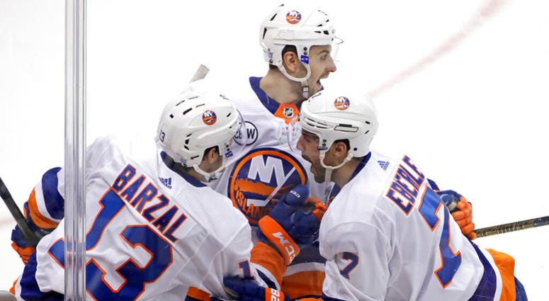 New York Islanders' Jordan Eberle (7) celebrates with Adam Pelech, center, and Mathew Barzal (13) after scoring against the Pittsburg Penguins during the first period in Game 4 of an NHL first-round hockey playoff series in Pittsburgh, Tuesday, April 16, AP DO NOT USE