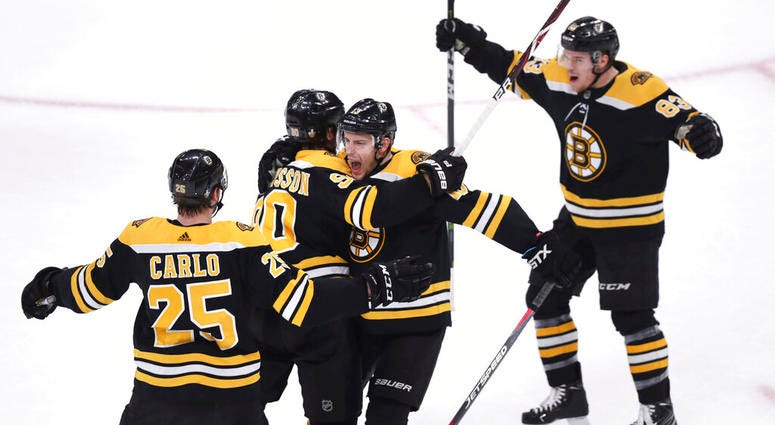 Boston Bruins left wing Marcus Johansson, second from left, is congratulated by teammates after his goal off Toronto Maple Leafs goaltender Frederik Andersen during the first period of Game 7 of an NHL hockey first-round playoff series AP DO NOT USE