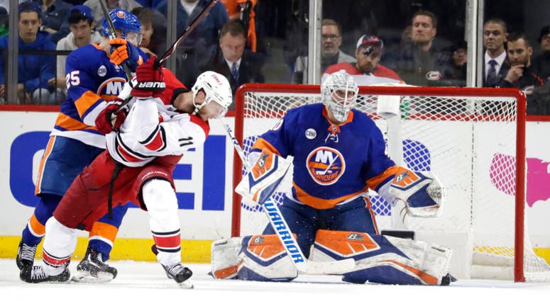 New York Islanders goaltender Robin Lehner, of Sweden, eyes the puck as teammate defenseman Devon Toews (25) blocks Carolina Hurricanes center Jordan Staal (11) during the second period of Game 1 of an NHL hockey second-round playoff series, Friday, April AP DO NOT USE
