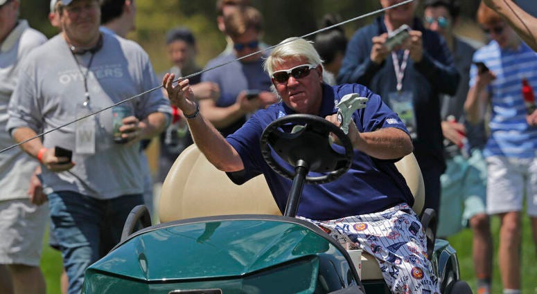 John Daly lifts a rope to get his golf cart to the 12th tee during the first round of the PGA Championship golf tournament, Thursday, May 16, 2019, at Bethpage Black in Farmingdale, N.Y. AP DO NOT USE