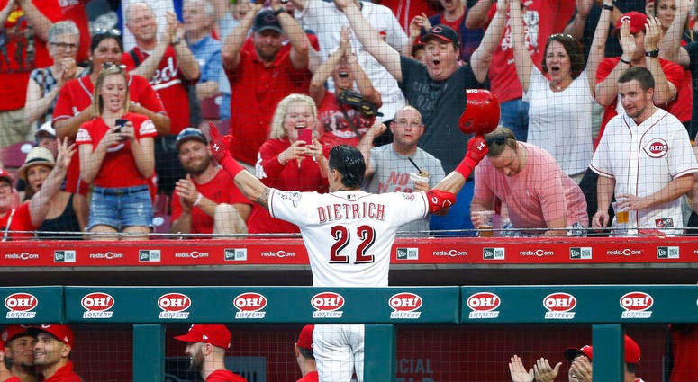 Cincinnati Reds' Derek Dietrich (22) acknowledges the fans following a two-run home run off Pittsburgh Pirates relief pitcher Geoff Hartlieb, his third of the game, during the seventh inning of a baseball game, Tuesday, May 28, 2019, in Cincinnati. ap do not use