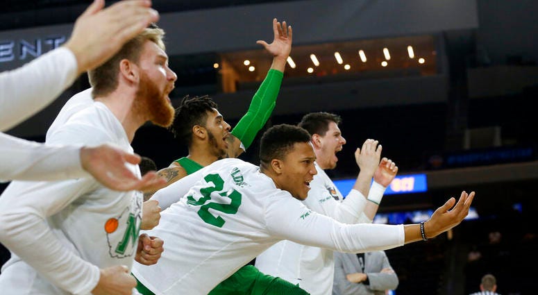 In this Saturday, March 10, 2018, file photo, then-Marshall guard Phil Bledsoe (32) and the Marshall bench react to a 3-point shot against Western Kentucky during the second half of the NCAA Conference USA basketball championship game in Frisco, Texas. AP DO NOT USE
