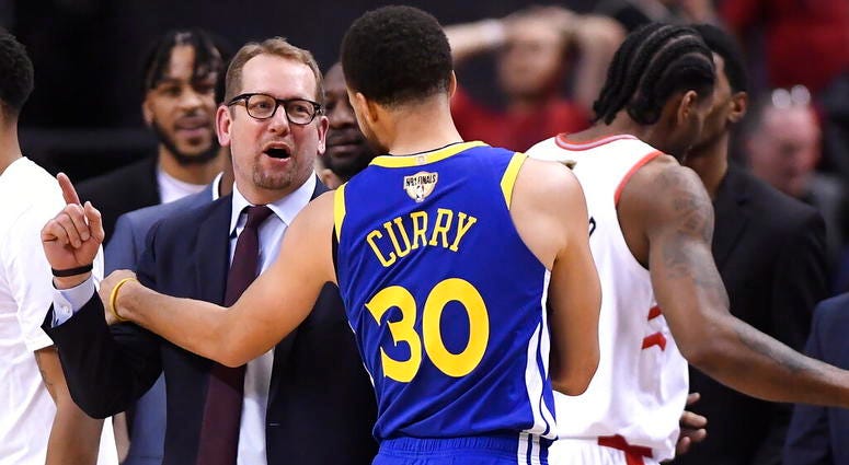 Toronto Raptors head coach Nick Nurse and Golden State Warriors guard Stephen Curry (30) exchange words on the court during second half of Game 2 of basketball’s NBA Finals, Sunday, June 2, 2019, in Toronto. AP DO NOT USE
