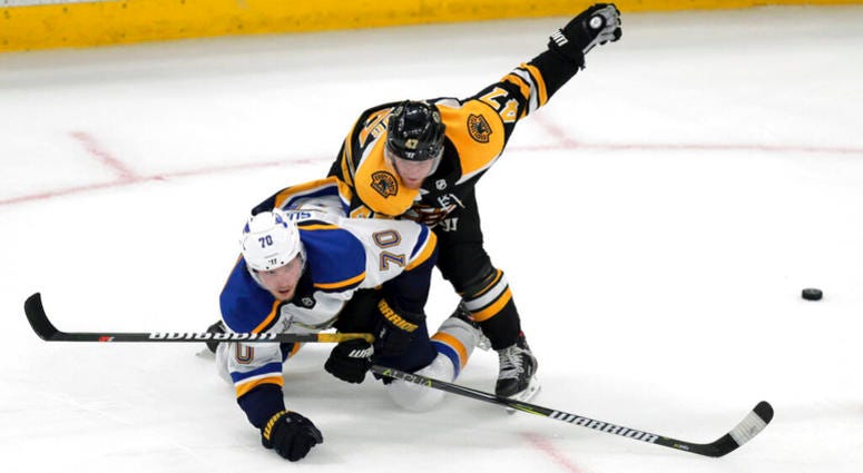 Boston Bruins' Torey Krug (47) checks St. Louis Blues' Oskar Sundqvist (70), of Sweden, to the ice during the second period in Game 5 of the NHL hockey Stanley Cup Final, Thursday, June 6, 2019, in Boston AP DO NOT USE