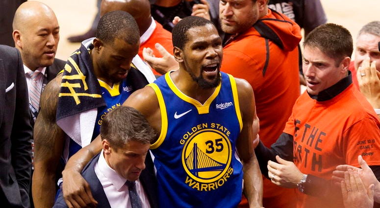 Golden State Warriors forward Kevin Durant (35) reacts as he leaves the court after sustaining an injury during first-half basketball action against the Toronto Raptors in Game 5 of the NBA Finals in Toronto, Monday, June 10, 2019. AP DO NOT USE