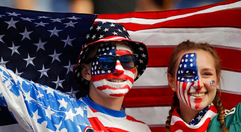 Austin, left, and Jordyn Chambers, from Philadelphia, hold up an US flag prior the Women's World Cup Group F soccer match between United States and Chile at Parc des Princes in Paris, France, Sunday, June 16, 2019. Austin, left, and Jordyn Chambers, from Philadelphia, hold up an US flag prior the Women's World Cup Group F soccer match between United States and Chile at Parc des Princes in Paris, France, Sunday, June 16, 2019.