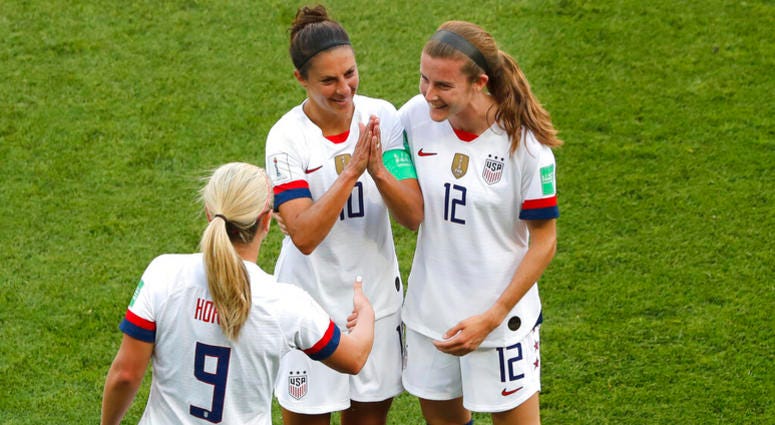 United States' Carli Lloyd , center, celebrates with Lindsey Horan and Tierna Davidson, right, after scoring the opening goal during the Women's World Cup Group F soccer match between the United States and Chile at the Parc des Princes in Paris, Sunday, J AP DO NOT USE