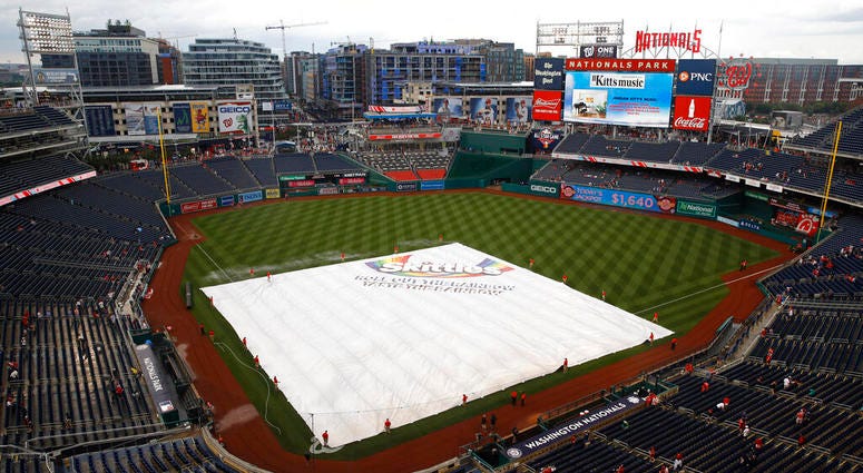 A tarp covers the infield during a rain delay before a baseball game between the Philadelphia Phillies and the Washington Nationals, Monday, June 17, 2019, in Washington.