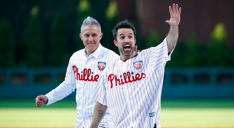 Actor Rob McElhenney, right, one of the creators of "It's Always Sunny in Philadelphia," reacts after catching a ceremonial first pitch from former Philadelphia Phillies player Chase Utley Actor Rob McElhenney, right, one of the creators of "It's Always Sunny in Philadelphia," reacts after catching a ceremonial first pitch from former Philadelphia Phillies player Chase Utley