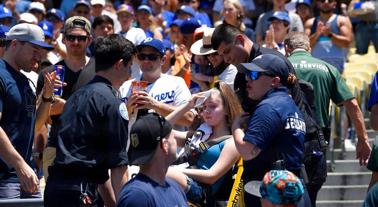 A young fan is carted away after being hit with a foul ball hit by Los Angeles Dodgers' Cody Bellinger during the first inning of a baseball game against the Colorado Rockies, Sunday, June 23, 2019, in Los Angeles. A young fan is carted away after being hit with a foul ball hit by Los Angeles Dodgers' Cody Bellinger during the first inning of a baseball game against the Colorado Rockies, Sunday, June 23, 2019, in Los Angeles.