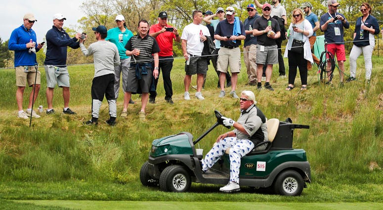 n this May 17, 2019 file photo, John Daly drives his cart off the 16th tee during the second round of the PGA Championship golf tournament, at Bethpage Black in Farmingdale, N.Y.