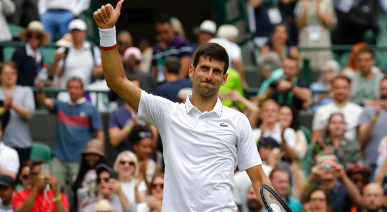 Serbia's Novak Djokovic celebrates defeating Ugo Humbert of France in a men's singles match during day seven of the Wimbledon Tennis Championships in London, Monday, July 8, 2019. AP DO NOT USE