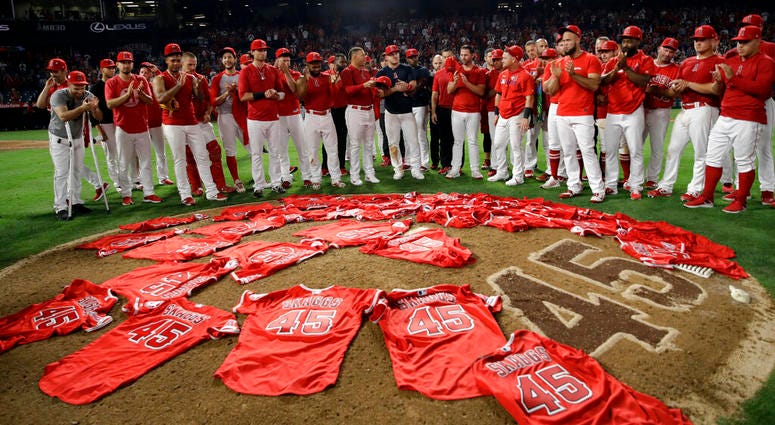 Members of the Los Angeles Angels place their jerseys with No. 45 in honor of pitcher Tyler Skaggs AP DO NOT USE