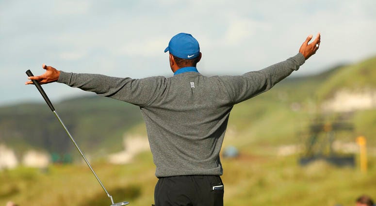 Tiger Woods of the United States celebrates after getting a birdie on the 16th green during the first round of the British Open Golf Championships at Royal Portrush in Northern Ireland, Thursday, July 18, 2019.
