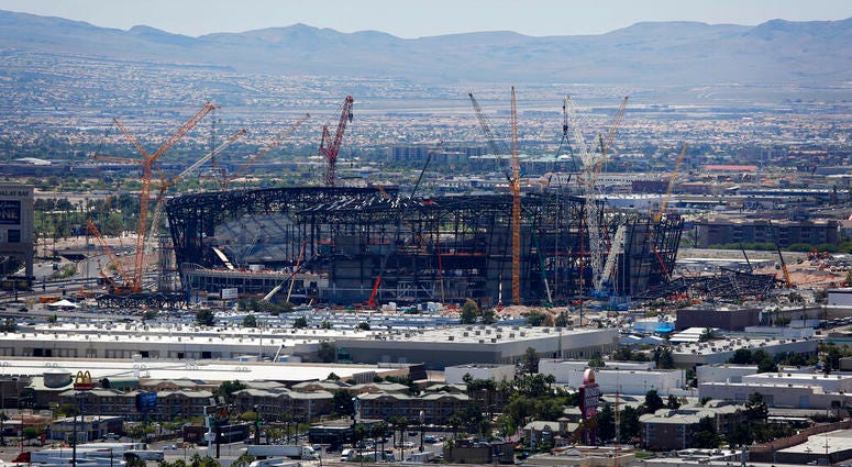 In this June 4, 2019, file photo, construction cranes surround the football stadium under construction in Las Vegas.