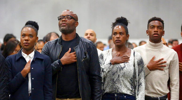 Mixed martial arts great Anderson "Spider" Silva of Brazil, his daughter Kaory, 23, left, his wife Dayane and son Kalyl, 20, right, recite the Pledge of Allegiance after all but Dayane were sworn in as U.S. citizens in a mass naturalization ceremony Tuesd Mixed martial arts great Anderson "Spider" Silva of Brazil, his daughter Kaory, 23, left, his wife Dayane and son Kalyl, 20, right, recite the Pledge of Allegiance after all but Dayane were sworn in as U.S. citizens in a mass naturalization ceremony Tuesd