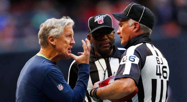 Seattle Seahawks head coach Pete Carroll speaks to back judge Perry Paganelli (46) during the second half of an NFL football game against the Atlanta Falcons, Sunday, Oct. 27, 2019, in Atlanta.