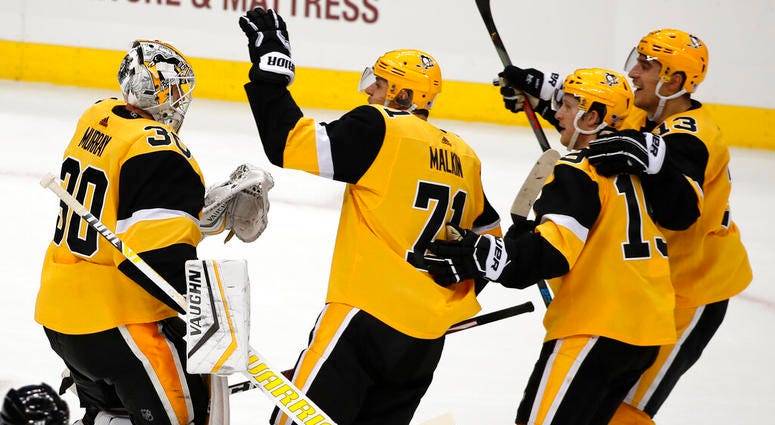Pittsburgh Penguins goaltender Matt Murray (30) celebrates a shootout win over the Chicago Blackhawks with Evgeni Malkin (71), Jared McCann (19) and Brandon Tanev (13) following an NHL hockey game in Pittsburgh, Saturday, Nov. 9, 2019. AP DO NOT USE