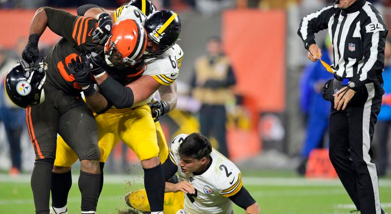 Cleveland Browns defensive end Myles Garrett (95) takes Pittsburgh Steelers quarterback Mason Rudolph's (2) helmet off during the second half of an NFL football game Thursday, Nov. 14, 2019, in Cleveland. Mason Rudolph