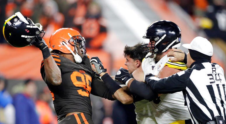 Cleveland Browns defensive end Myles Garrett, left, gets ready to hit Pittsburgh Steelers quarterback Mason Rudolph, second from left, with a helmet during the second half of an NFL football game, Thursday, Nov. 14, 2019, in Cleveland. Cleveland Browns defensive end Myles Garrett, left, gets ready to hit Pittsburgh Steelers quarterback Mason Rudolph, second from left, with a helmet during the second half of an NFL football game, Thursday, Nov. 14, 2019, in Cleveland.