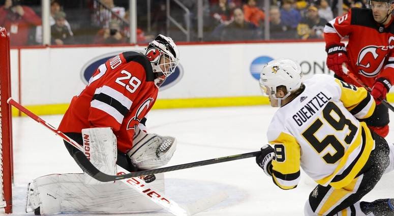 New Jersey Devils goaltender Mackenzie Blackwood (29) stops a shot by Pittsburgh Penguins' Jake Guentzel (59) during the first period of an NHL hockey game Friday, Nov. 15, 2019, in Newark, N.J. New Jersey Devils goaltender Mackenzie Blackwood (29) stops a shot by Pittsburgh Penguins' Jake Guentzel (59) during the first period of an NHL hockey game Friday, Nov. 15, 2019, in Newark, N.J.