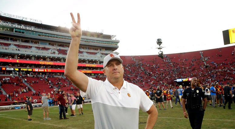 Southern California head coach Clay Helton signals to fans from midfield after a 52-35 win over UCLA in an NCAA college football game, Saturday, Nov. 23, 2019, in Los Angeles. Southern California head coach Clay Helton signals to fans from midfield after a 52-35 win over UCLA in an NCAA college football game, Saturday, Nov. 23, 2019, in Los Angeles.