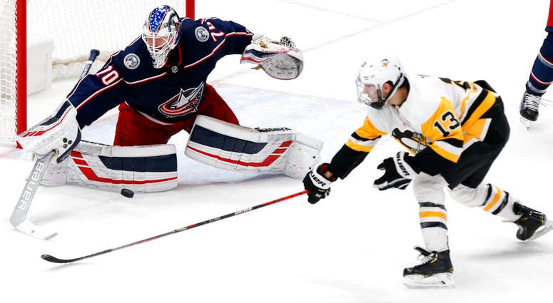 Columbus Blue Jackets goalie Joonas Korpisalo, left, of Finland, stops a shot by Pittsburgh Penguins forward Brandon Tanev during the third period of an NHL hockey game in Columbus, Ohio, Friday, Nov. 29, 2019. AP DO NOT USE