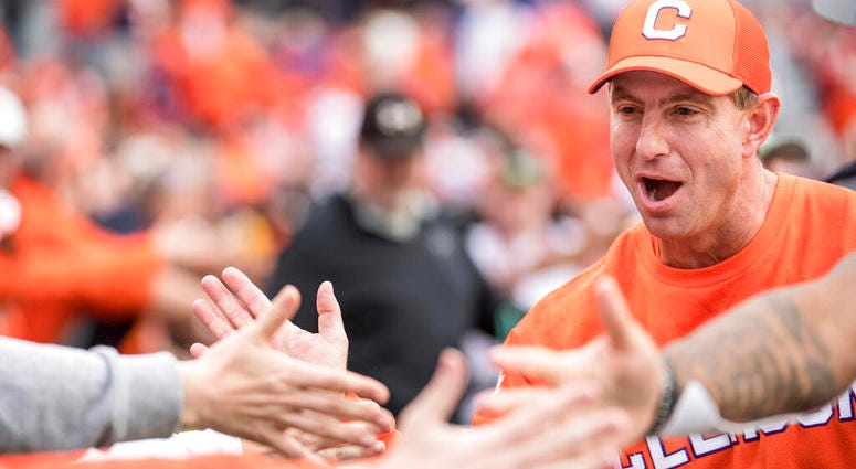 Clemson head coach Dabo Swinney high-fives fans after an NCAA college football game against South Carolina, Saturday, Nov. 30, 2019, in Columbia, S.C. Clemson won 38-3. Clemson head coach Dabo Swinney high-fives fans after an NCAA college football game against South Carolina, Saturday, Nov. 30, 2019, in Columbia, S.C. Clemson won 38-3.