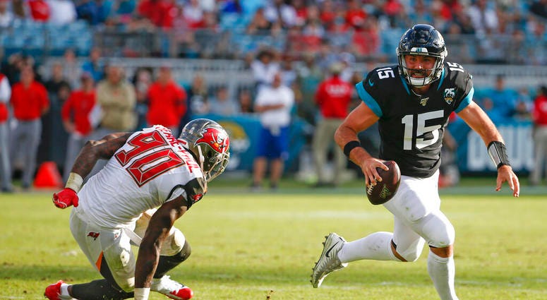 Jacksonville Jaguars quarterback Gardner Minshew (15) scrambles away from Tampa Bay Buccaneers linebacker Jason Pierre-Paul (90) during the second half of an NFL football game, Sunday Dec. 1, 2019, in Jacksonville, Fla. Jacksonville Jaguars quarterback Gardner Minshew (15) scrambles away from Tampa Bay Buccaneers linebacker Jason Pierre-Paul (90) during the second half of an NFL football game, Sunday Dec. 1, 2019, in Jacksonville, Fla.