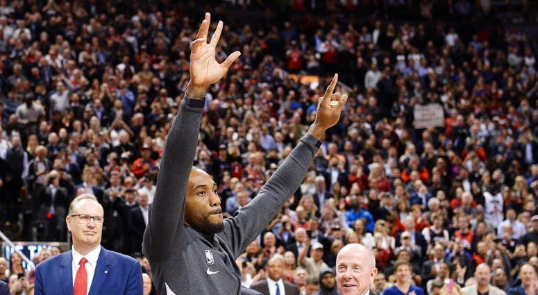 Former Toronto Raptors and now Los Angeles Clippers forward Kawhi Leonard salutes the crowd as he receives his 2019 NBA championship ring prior to an NBA basketball game, Wednesday, Dec. 11, 2019, in Toronto. Former Toronto Raptors and now Los Angeles Clippers forward Kawhi Leonard salutes the crowd as he receives his 2019 NBA championship ring prior to an NBA basketball game, Wednesday, Dec. 11, 2019, in Toronto.