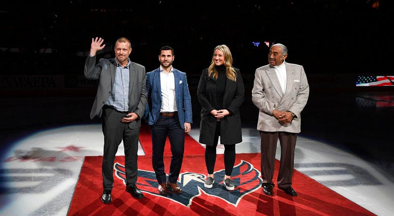 The 2019 U.S. Hockey Hall of Fame class, from left to right, Tim Thomas, Brian Gionta, Krissy Wendell and Neal Henderson stand on the ice before a ceremonial puck drop ahead of an NHL hockey game The 2019 U.S. Hockey Hall of Fame class, from left to right, Tim Thomas, Brian Gionta, Krissy Wendell and Neal Henderson stand on the ice before a ceremonial puck drop ahead of an NHL hockey game