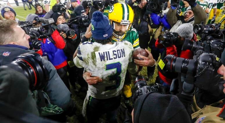 Green Bay Packers' Aaron Rodgers talks to Seattle Seahawks' Russell Wilson after an NFL divisional playoff football game Sunday, Jan. 12, 2020, in Green Bay, Wis. AP DO NOT USE