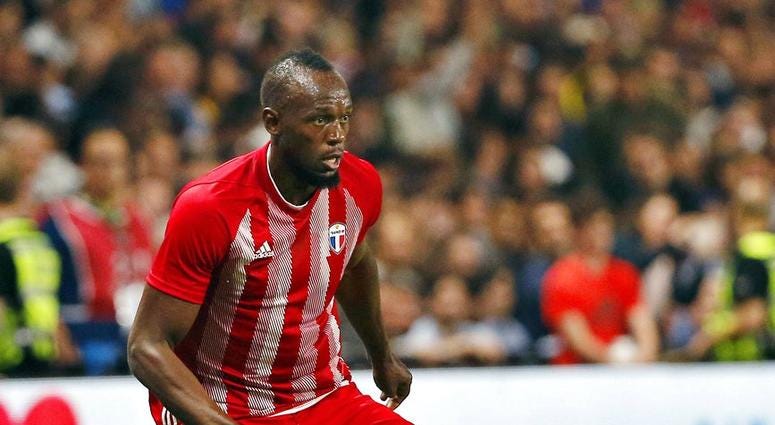 former Olympic and Jamaican sprinter Usain Bolt controls the ball during a charity soccer match between members of the 1998 World Cup winning French team and a team of international veteran players DO NOT USE