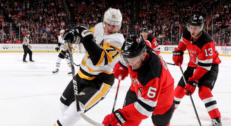 Andy Greene #6 of the New Jersey Devils takes the puck as Evgeni Malkin #71 of the Pittsburgh Penguins defends Andy Greene #6 of the New Jersey Devils takes the puck as Evgeni Malkin #71 of the Pittsburgh Penguins defends