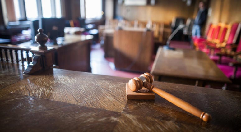 Color image of a hammer in a courtroom. Color image of a hammer in a courtroom.