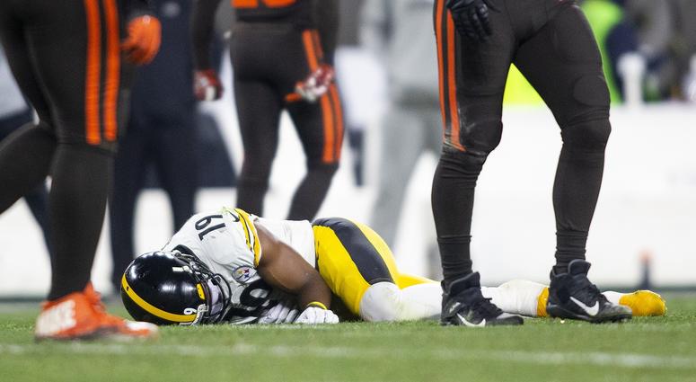 Pittsburgh Steelers wide receiver JuJu Smith-Schuster (19) lays on the field from an injury during the first quarter against the Cleveland Browns at FirstEnergy Stadium.