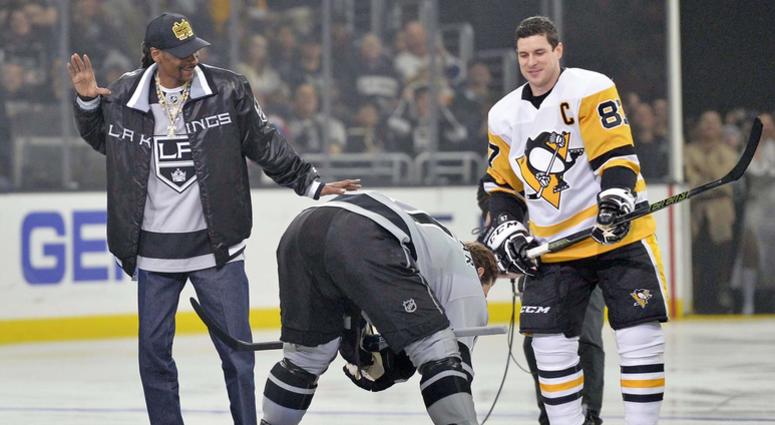 Hip-Hop artist Snoop Dogg reacts after dropping the puck before the game in front of Pittsburgh Penguins center Crosby