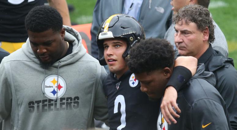 Mason Rudolph being helped off the field after suffering a concussion
