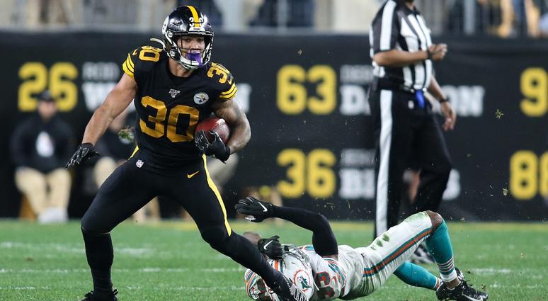 James Conner evading a tackle against the Dolphins James Conner